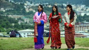 TO GO WITH Bhutan-politics-economy-health-labour-social-youth,FEATURE by Rachel O'BRIEN Schoolgirls wear traditional Bhutanese dresses before a cultural event to celebrate the birth date of Bhutan's fourth king at a local school in Thimphu on June 2, 2013. It is known as "the last Shangri-La" -- a remote Himalayan nation, rich in natural beauty and Buddhist culture, where national happiness is prioritised over economic growth. But urban youngsters in the kingdom of Bhutan are quick to challenge its rosy reputation. AFP PHOTO/ROBERTO SCHMIDT (Photo credit should read ROBERTO SCHMIDT/AFP/Getty Images)